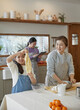 © stciel - Happy adorable little child girl in apron enjoying cooking homemade pastry together with family at home.