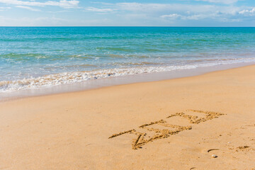 2021 year sign hand written sandy beach sunny outdoors background.