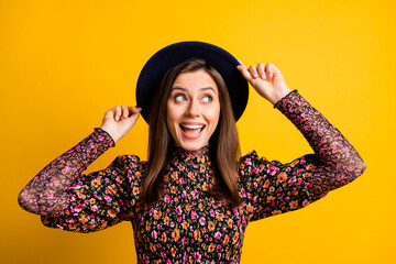 Sticker - Portrait of impressed nice lady hand cap look empty space wear black shirt isolated on vibrant yellow color background