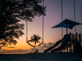 Wall Mural - sunrise on the beach with palm trees park fun children clouds sky beautiful florida