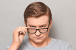 © Andrei Korzhyts - Portrait of blond mature man looking attentively over his glasses