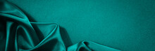 Blue Green Silk Satin Background. Soft Wavy Folds On Smooth, Shiny Fabric. Dark Teal Luxury Background With Copy Space For Design. Web Banner.