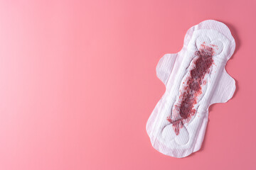 Wall Mural - Used Sanitary pad, Sanitary napkin on pink background. Menstruation, Feminine hygiene, top view.