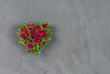 Sprouted Microgreens Of Amaranth, Red Cabbage, Heart-shaped Radish. Germinating Microgreen Seeds At Home. View From Above. Vegan And Healthy Food Concept. Place For An Inscription.