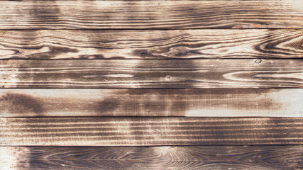 Aufkleber - Wooden floor with traces of being burnt makes a black abstract background and texture.