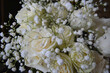White roses and gypsophila on a black background. Beautiful festive bouquet. 