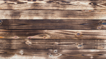 Aufkleber - Wooden floor with traces of being burnt makes a black abstract background and texture.