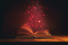 Magical Image Of Open Antique Book Over Wooden Table With Glitter Overlay
