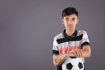 Wall Mural - Smiling Indian teen boy holding soccer ball or football	
