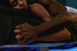 © Svitlana - My love, my world. Young african sensual couple in love holding hands while sleeping together on the bed after having sex