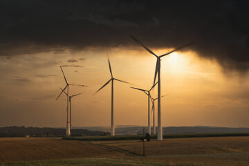  wind turbines on field in bad weather