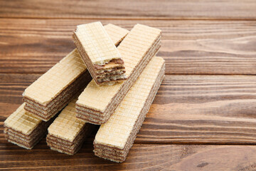 Poster - Sweet wafer sticks on brown wooden background