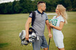© prostooleh - Couple in a golf course. Blonde in a sport clothes. Pair playing golf