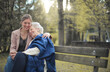 © olly - grandson with grandmother huddled in a park