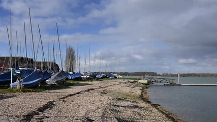 Wall Mural - A small beach as Chichester Marina with dinghies stored in the boatyard. 