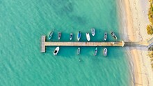 Aerial View Of Boats Moored In Sea By Pier
