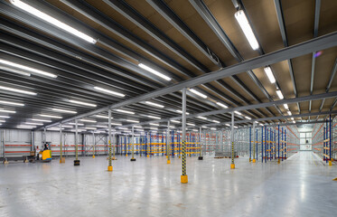 Interior of huge empty storehouse. Industrial warehouse racking.