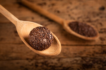 Sticker - Chocolate brigadeiro in wooden spoon. Brigadeiro, traditional Brazilian sweet.