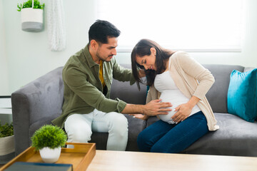 Wall Mural - Distressed pregnant woman having contractions at home