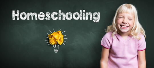 Wall Mural - young smiling girl in front of blackboard with message HOMESCHOOLING