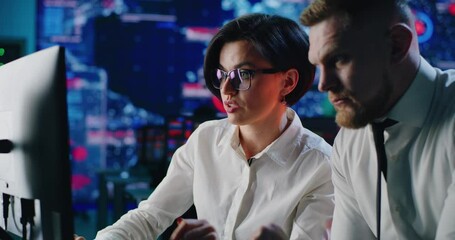 Colleagues analyzing security data on computer