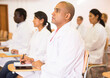 © JackF - Focused Hispanic man participating in medical congress with colleagues, listening attentively to lecturer
