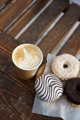 Wall Mural - Street food and coffee on a wooden table in the street in winter