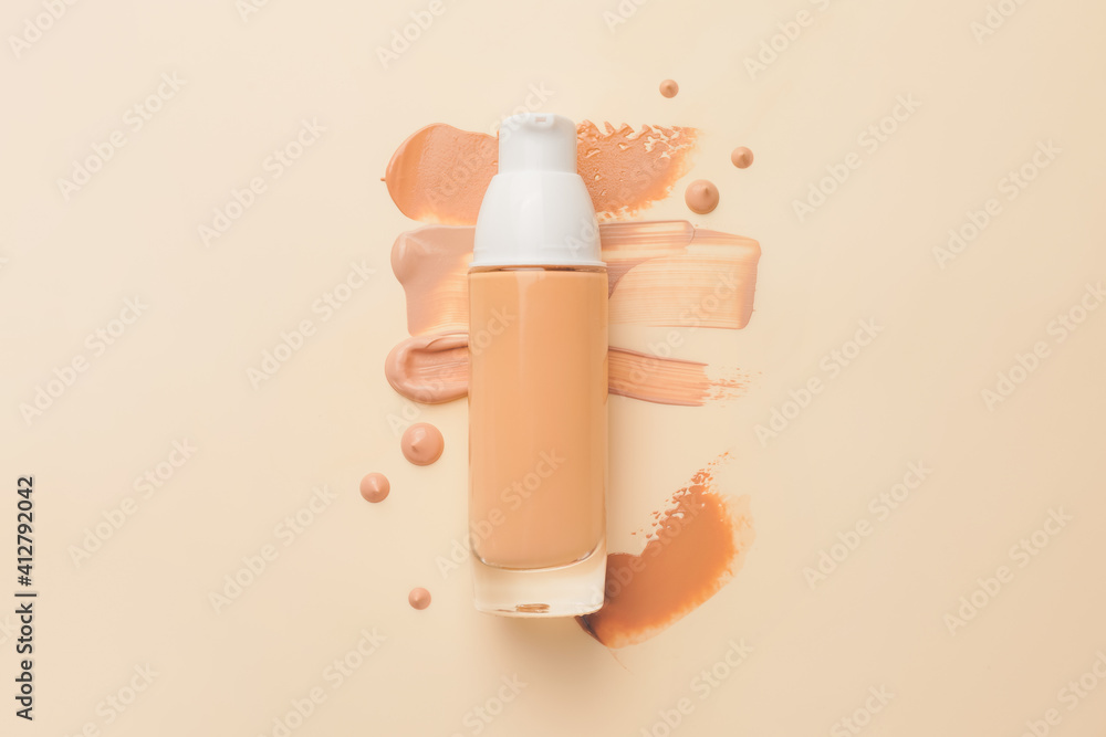 Bottle of makeup foundation and samples on color background