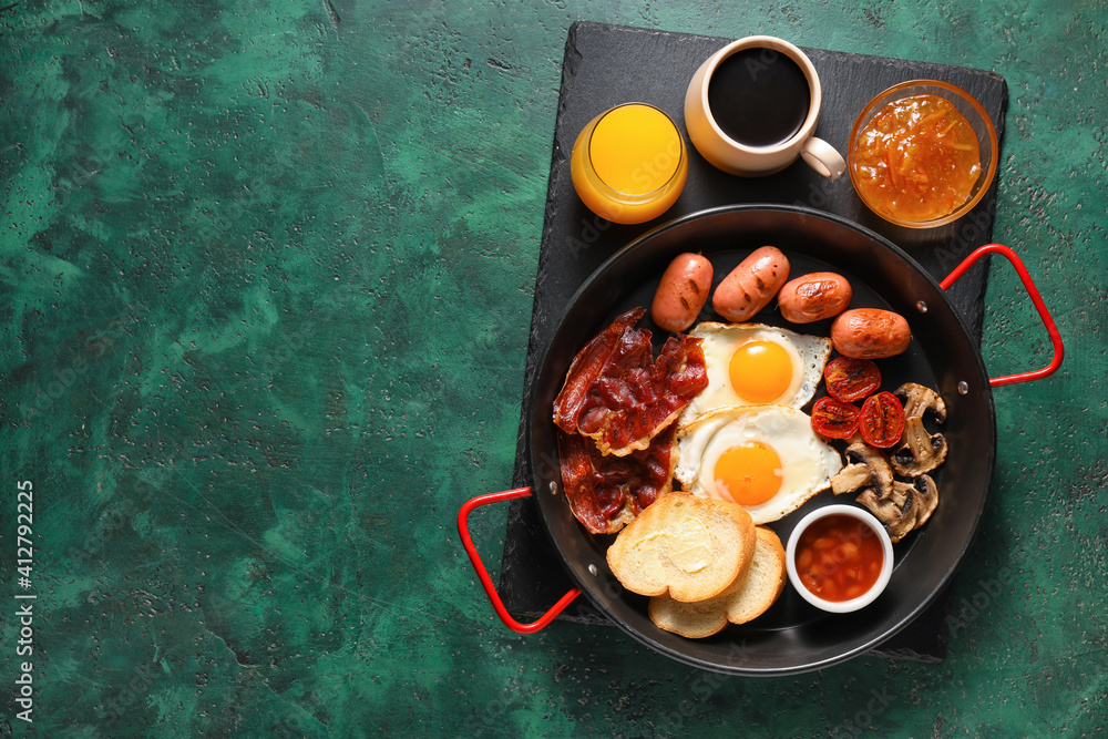 Traditional English breakfast with fried eggs in pan on color background