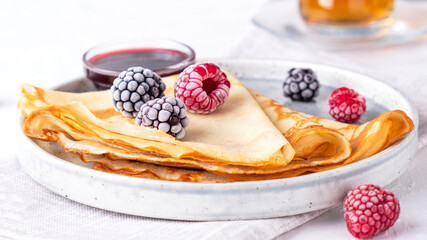 Pancakes with berries. Delicious crepe on a plate