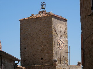 Wall Mural - Closeup of the bell tower of Santa Maria del Giglio Church in Castiglione della Pescaia.