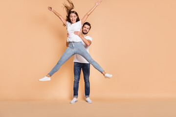 Sticker - Full length photo of two cheerful people man hands hold lady make star figure isolated on beige color background