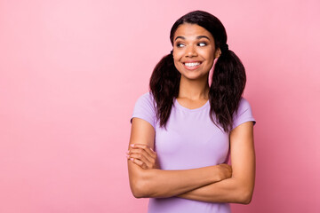 Wall Mural - Photo of curious afro american woman look empty space hold folded hands isolated on pink color background