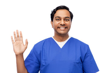 healthcare, profession and medicine concept - happy smiling indian doctor or male nurse in blue unif
