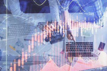 Double exposure of man and woman working together and financial graph hologram drawing. market analysis concept. Computer background. Top View.