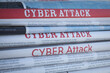 © New Africa - Stacked newspapers with headlines CYBER ATTACK as background, closeup