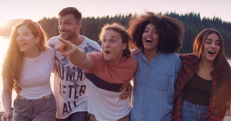 Group of happy friends walk through nature on lake beach wav hands close friendship and tourism travel party concept slow motion shot on red epic w