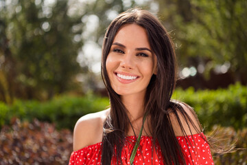 Poster - Photo of adorable sweet young woman dressed red off-shoulders dress walking smiling outdoors street city urban