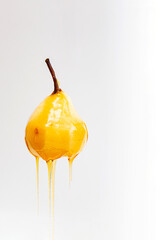 Pear in caramel syrup isolated on white background. Vegan and healthy food concept