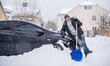 © T.Den_Team - Winter, people and car problem concept. Man try on pushing the car, stuck in the snow. Mutual aid. Winter problem. transportation, winter and vehicle concept - closeup of man pushing car stuck in snow