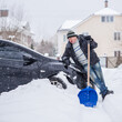 © T.Den_Team - Winter, people and car problem concept. Man try on pushing the car, stuck in the snow. Mutual aid. Winter problem. transportation, winter and vehicle concept - closeup of man pushing car stuck in snow