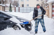 © T.Den_Team - Winter, people and car problem concept. Man try on pushing the car, stuck in the snow. Mutual aid. Winter problem. transportation, winter and vehicle concept - closeup of man pushing car stuck in snow