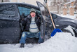 © T.Den_Team - Winter, people and car problem concept. Man try on pushing the car, stuck in the snow. Mutual aid. Winter problem. transportation, winter and vehicle concept - closeup of man pushing car stuck in snow