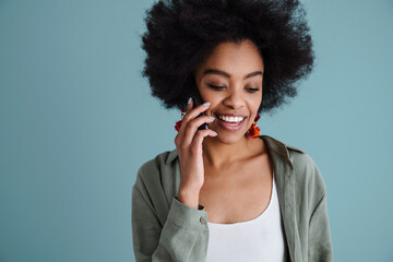 Wall Mural - Happy african american girl smiling while talking on mobile phone