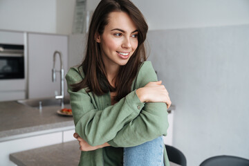 Cheerful beautiful woman smiling and looking aside