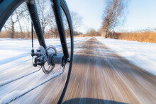 Front Bicycle Wheel Spinning Motion Blur. Bicycling On Slippery Snow