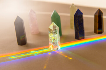 Healing chakra crystals and rainbow on beige background. Meditation, reiki and spiritual healing concept