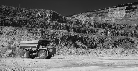 Wall Mural - Mining dump truck in limestone quarry, black and white panorama.