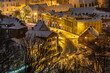 View of the illuminated, snow-covered old town in Oliwa. Gdansk, Poland.