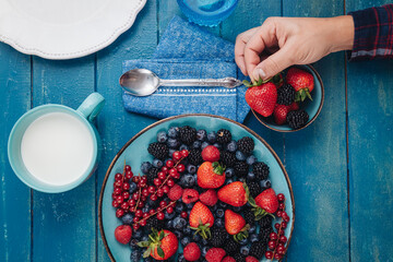 Sticker - Healthy breakfast eating a mix of fresh berries fruits